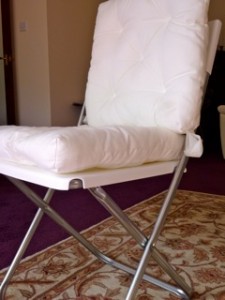 White folding chair with detachable cushions