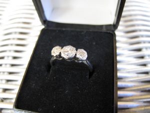 Lot 245 - White gold ring with three stones - Sold for £80