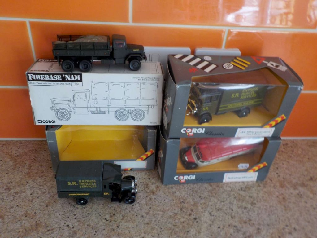 Corgi lorries and a coach in boxes