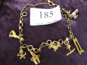 Lot 185 - 9ct gold charm bracelet with 7 charms including: The old woman who lived in a shoe and her children - Sold for £200
