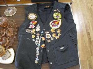 Lot 201 - Leather biker waistcoat with badges - Sold for £45