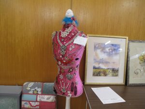 Lot 166 - Pink mannequin with hallmarked silver and costume jewellery - Sold for £45