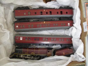 Lot 70 - Triang Maroon Prices Locomotive and three coaches - Sold for £55