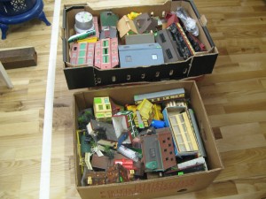 A collection of toy train buildings and rolling stock