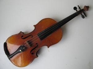 Violin 7/8 size scratches to varnish but no cracks or chips. No makers name. Resonates nicely. Recently restrung.