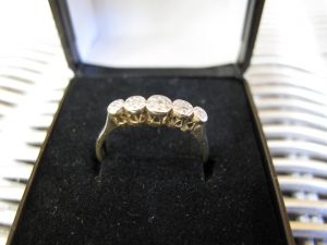 Lot 247 - Gold ring with five stones - Sold for £80