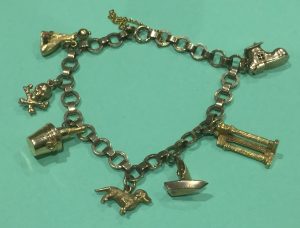 A traditional gold charm bracelet with seven charms on a lovely 9ct chain. The pick of the charms being the shoe, when opened it shows the old lady who lives in a shoe! Estimate £200-£250