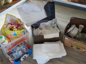 Tin trunk of linen, baby and dolls clothes £30