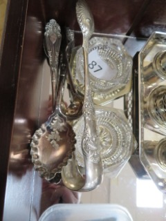 Silver candle holders, tongs and spoons sold for £95
